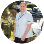 Reablement worker stands in front of a river.